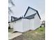 Side view of a white two-story house showing the siding and exterior features at 310 N Monroe St, Muncie, IN 47305