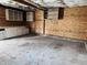 This garage has concrete flooring, cabinets, shelves and OSB paneling at 310 N Monroe St, Muncie, IN 47305