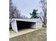 Spacious garage featuring an open carport and a separate door for access at 310 N Monroe St, Muncie, IN 47305