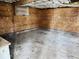 This garage has concrete flooring and OSB-paneled walls and ceiling at 310 N Monroe St, Muncie, IN 47305