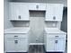 Kitchen featuring white cabinets and countertops, with black hardware at 310 N Monroe St, Muncie, IN 47305