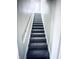 Carpeted staircase leading to the upper level of the home at 310 N Monroe St, Muncie, IN 47305