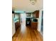 Kitchen featuring wood floors, black appliances, and stainless steel microwave at 3126 Newhart St, Indianapolis, IN 46217