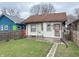 Cozy home featuring a small backyard with a grassy area and a pathway at 330 N Beville Ave, Indianapolis, IN 46201