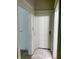 Hallway with a six-panel door, tile floor, and an open doorway to another room at 330 N Beville Ave, Indianapolis, IN 46201