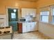 Functional kitchen featuring white cabinets and a view into the living room at 330 N Beville Ave, Indianapolis, IN 46201