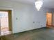 Bright living room leading to an adjacent bathroom with a decorative glass window at 330 N Beville Ave, Indianapolis, IN 46201