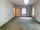 Spacious living room with natural light and classic chandelier fixture at 330 N Beville Ave, Indianapolis, IN 46201