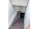Basement stairway with painted steps and walls leading to a lower level at 330 N Beville Ave, Indianapolis, IN 46201