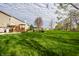 Spacious backyard featuring a wooden deck, pergola, and manicured lawn at 3393 Paisley Pointe, Whitestown, IN 46075