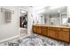 Bright bathroom features a double vanity, large mirror, and a doorway to the closet at 3393 Paisley Pointe, Whitestown, IN 46075