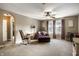 Spacious bedroom with large chair, rocking chair, and neutral tones with natural light at 3393 Paisley Pointe, Whitestown, IN 46075