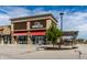 Exterior view of a City Barbeque restaurant featuring a red awning, with a tree and benches at 3393 Paisley Pointe, Whitestown, IN 46075