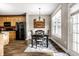 Inviting dining area with a table, chairs, modern light fixture, and view to the kitchen area at 3393 Paisley Pointe, Whitestown, IN 46075