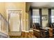 Bright foyer with hardwood floors, a staircase, and a view into a cozy living area at 3393 Paisley Pointe, Whitestown, IN 46075