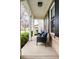 Inviting front porch with comfortable seating, offering a relaxing outdoor space with brick and white trim at 3393 Paisley Pointe, Whitestown, IN 46075