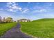 Picturesque view of a lush green field with a walking path and neighborhood homes at 3393 Paisley Pointe, Whitestown, IN 46075