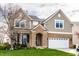 Charming two-story home featuring a brick entrance, lush green lawn, and inviting curb appeal at 3393 Paisley Pointe, Whitestown, IN 46075