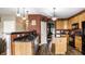 Well-equipped kitchen boasts wooden cabinets, stainless steel appliances, island, and stylish pendant lighting at 3393 Paisley Pointe, Whitestown, IN 46075