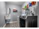 Well-organized laundry room with modern machines, sleek shelving, and convenient utility sink for everyday tasks at 3393 Paisley Pointe, Whitestown, IN 46075