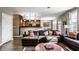 Open-concept living room and kitchen layout with hardwood floors and large leather sectional at 3393 Paisley Pointe, Whitestown, IN 46075
