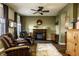 Warm living room with a fireplace, ceiling fan, and comfortable seating for relaxing evenings at 3393 Paisley Pointe, Whitestown, IN 46075