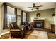 Cozy living room featuring a fireplace, hardwood floors, and comfortable leather recliners at 3393 Paisley Pointe, Whitestown, IN 46075