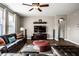 Relaxing living room with brown leather sofas, ceiling fan, and mounted flat screen TV at 3393 Paisley Pointe, Whitestown, IN 46075