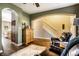 Inviting living room featuring arched doorways, hardwood floors, and comfortable leather chairs at 3393 Paisley Pointe, Whitestown, IN 46075