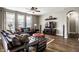 Comfortable living room with cozy seating, ceiling fan, and a large window providing ample natural light at 3393 Paisley Pointe, Whitestown, IN 46075