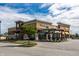 Exterior shot of a Starbucks featuring outside seating, and Verizon and Qdoba stores at 3393 Paisley Pointe, Whitestown, IN 46075