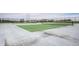 Well-maintained outdoor tennis courts, fenced-in, with a green playing surface ready for recreational activities and sports at 3393 Paisley Pointe, Whitestown, IN 46075