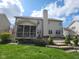 Spacious backyard featuring a screened porch, stone patio, and tiered landscaping at 3607 Mossy Rock Dr, Zionsville, IN 46077