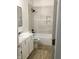 Bathroom with shower/tub combination, beige tile surround and floating shelves at 3643 Reflections Ln # 5, Indianapolis, IN 46214
