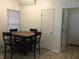 View of a dining room with wood floors, blind covered window and table with seating for four at 3643 Reflections Ln # 5, Indianapolis, IN 46214