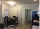 View of a dining room with wood floors, blind covered window and table with seating for four at 3643 Reflections Ln # 5, Indianapolis, IN 46214