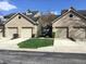 Charming townhouse exterior showcasing attached garages, well-maintained lawns and a classic brick facade at 3643 Reflections Ln # 5, Indianapolis, IN 46214