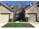 Charming townhouse exterior showcasing attached garages, well-maintained lawns and a classic brick facade at 3643 Reflections Ln # 5, Indianapolis, IN 46214