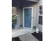 A welcoming front door with a charming sun decoration, potted plants, and a 'Welcome' sign creating a cozy entrance at 3643 Reflections Ln # 5, Indianapolis, IN 46214