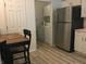 View of the kitchen with stainless refrigerator and adjacent laundry area with washer and dryer at 3643 Reflections Ln # 5, Indianapolis, IN 46214