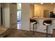 Kitchen pass through includes counter and chairs leading to the entryway at 3643 Reflections Ln # 5, Indianapolis, IN 46214