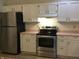 Well-lit kitchen features stainless steel appliances, including a refrigerator and range oven at 3643 Reflections Ln # 5, Indianapolis, IN 46214