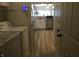 Convenient laundry area leading to the kitchen, equipped with modern appliances and ample natural light, and wood floors at 3643 Reflections Ln # 5, Indianapolis, IN 46214