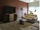 Inviting living room featuring modern furniture, a large TV, and stylish decor with neutral color scheme at 3643 Reflections Ln # 5, Indianapolis, IN 46214
