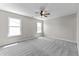 Spacious bedroom features neutral paint, carpet, windows, and ceiling fan for a serene and comfortable atmosphere at 4057 Knollwood Ave, Franklin, IN 46131