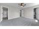 Spacious bedroom featuring ceiling fan, carpet, and views to ensuite bathroom and walk-in closet at 4057 Knollwood Ave, Franklin, IN 46131