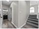 Hallway featuring staircase, gray flooring, bathroom access, and a window at 4057 Knollwood Ave, Franklin, IN 46131