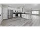 Open kitchen boasts stainless appliances, granite counters, and bright white cabinetry at 4057 Knollwood Ave, Franklin, IN 46131