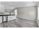 Bright eat-in kitchen featuring sleek stainless dishwasher, white cabinets and gray floors at 4057 Knollwood Ave, Franklin, IN 46131