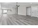 Spacious living room with modern gray floors, neutral walls, and a ceiling fan at 4057 Knollwood Ave, Franklin, IN 46131